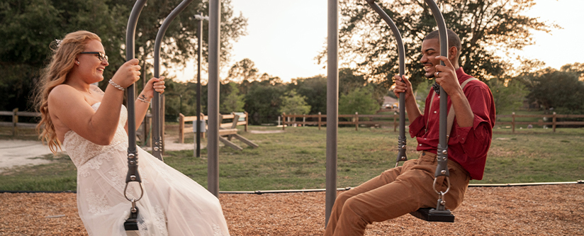 Engaged couple on swings