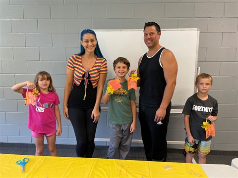 Instructor and students posing with their art project