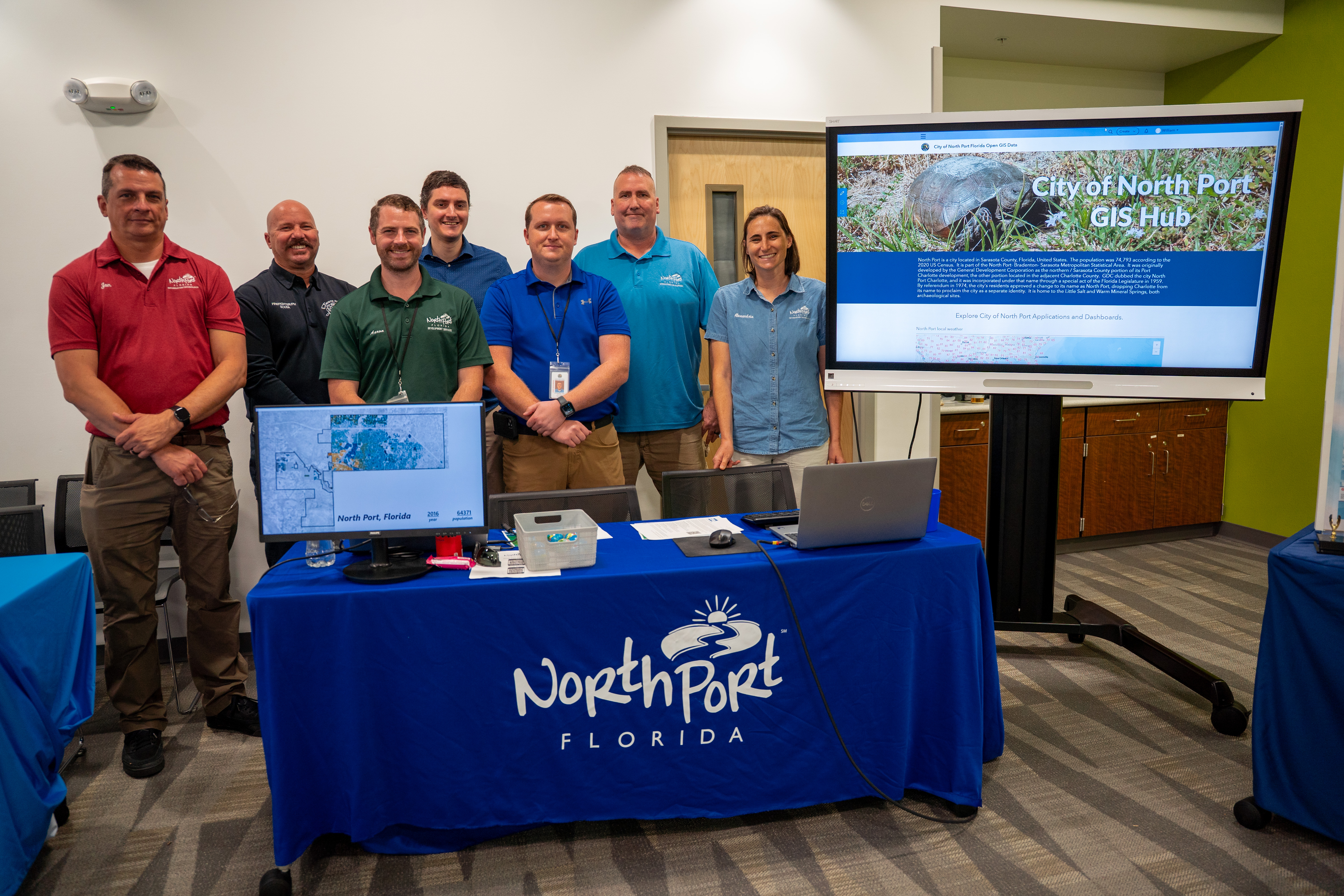 GIS staff standing next to digital display