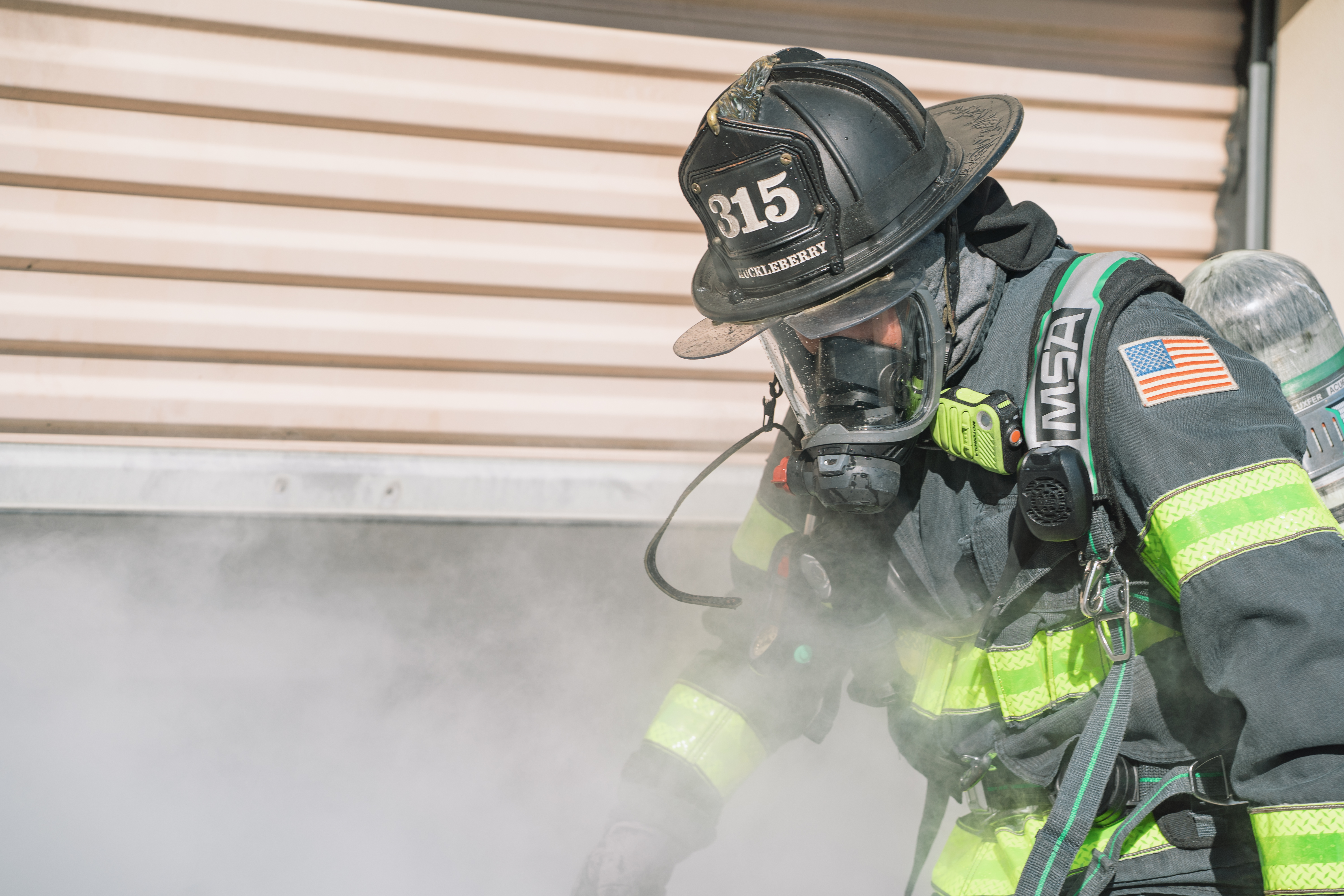 firefighter walking through smoke