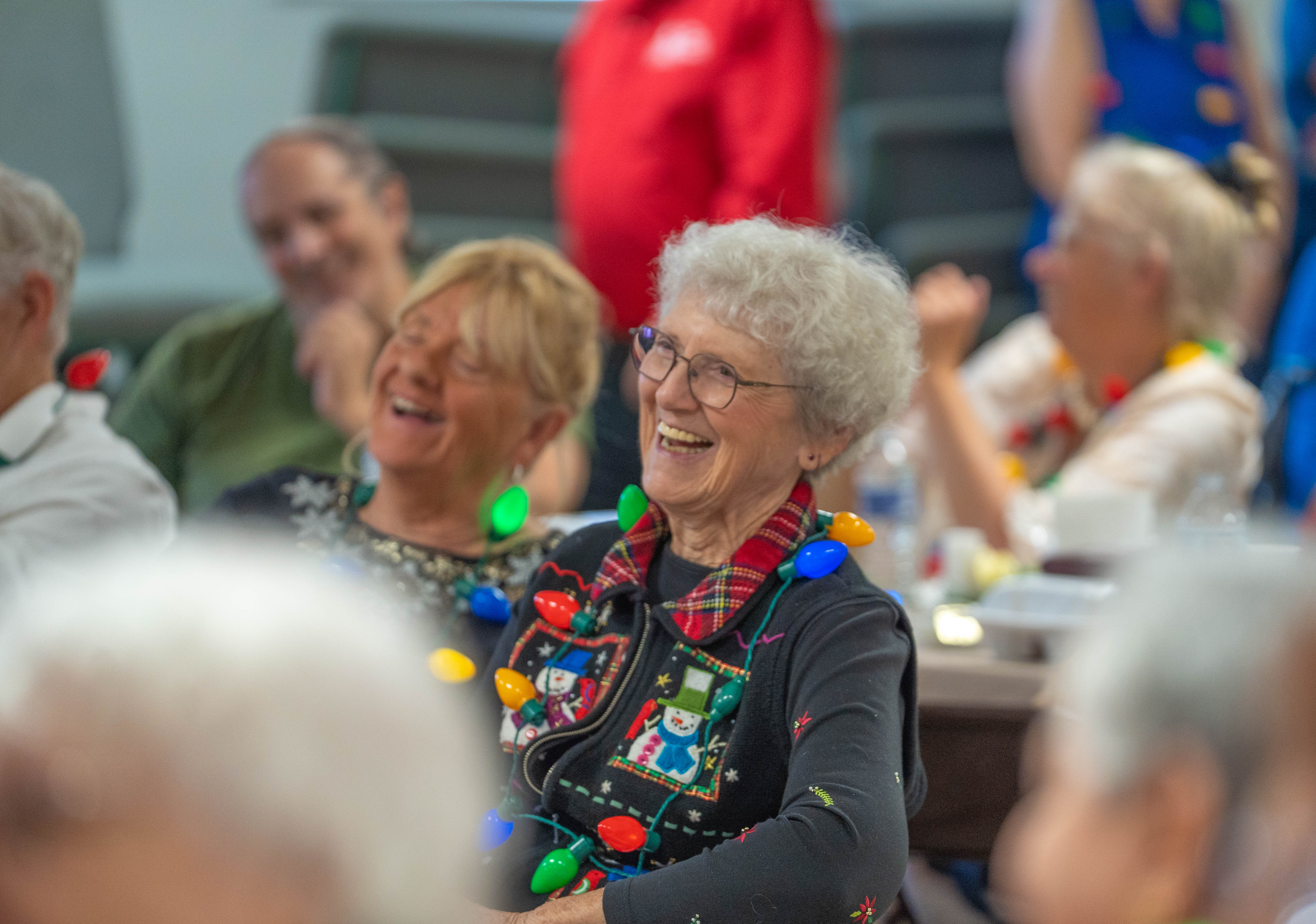 woman laughing at Senior Giving Tree event