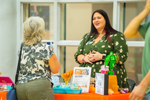 woman speaking to event attendee