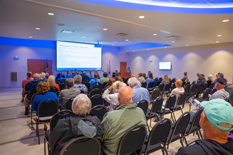 town hall attendees listening to presentation